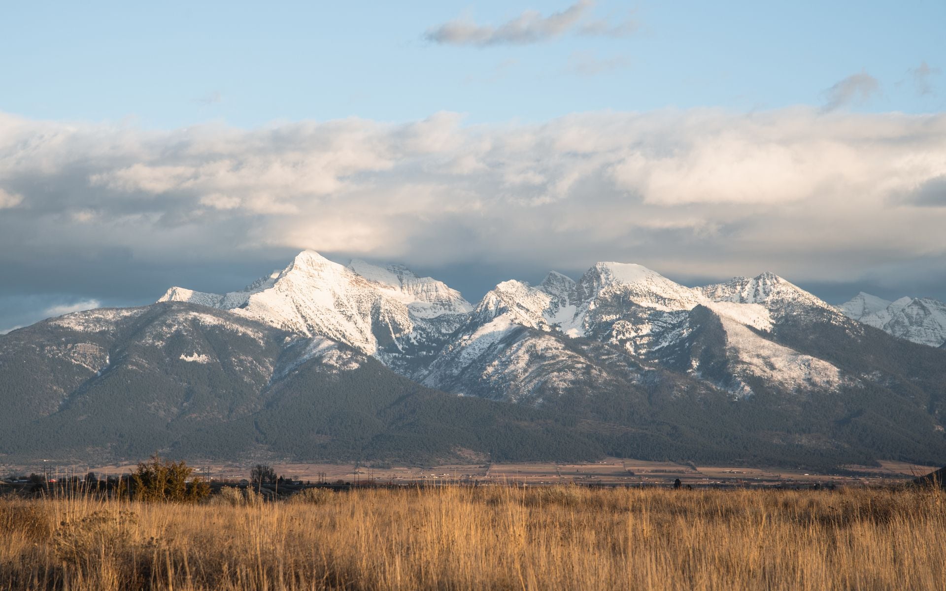 Snow-covered peaks above Big Sky Resort in Montana with empty ski runs on a clear winter morning